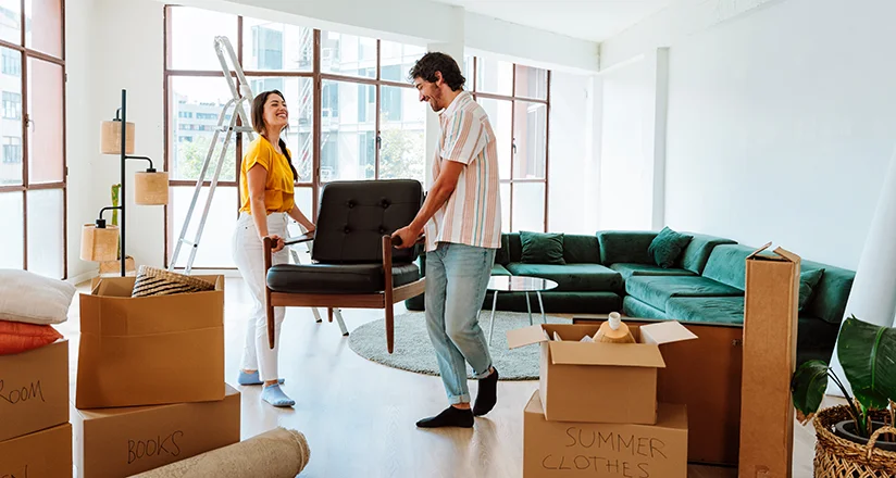 a couple moving furniture representing Move and Space Planning